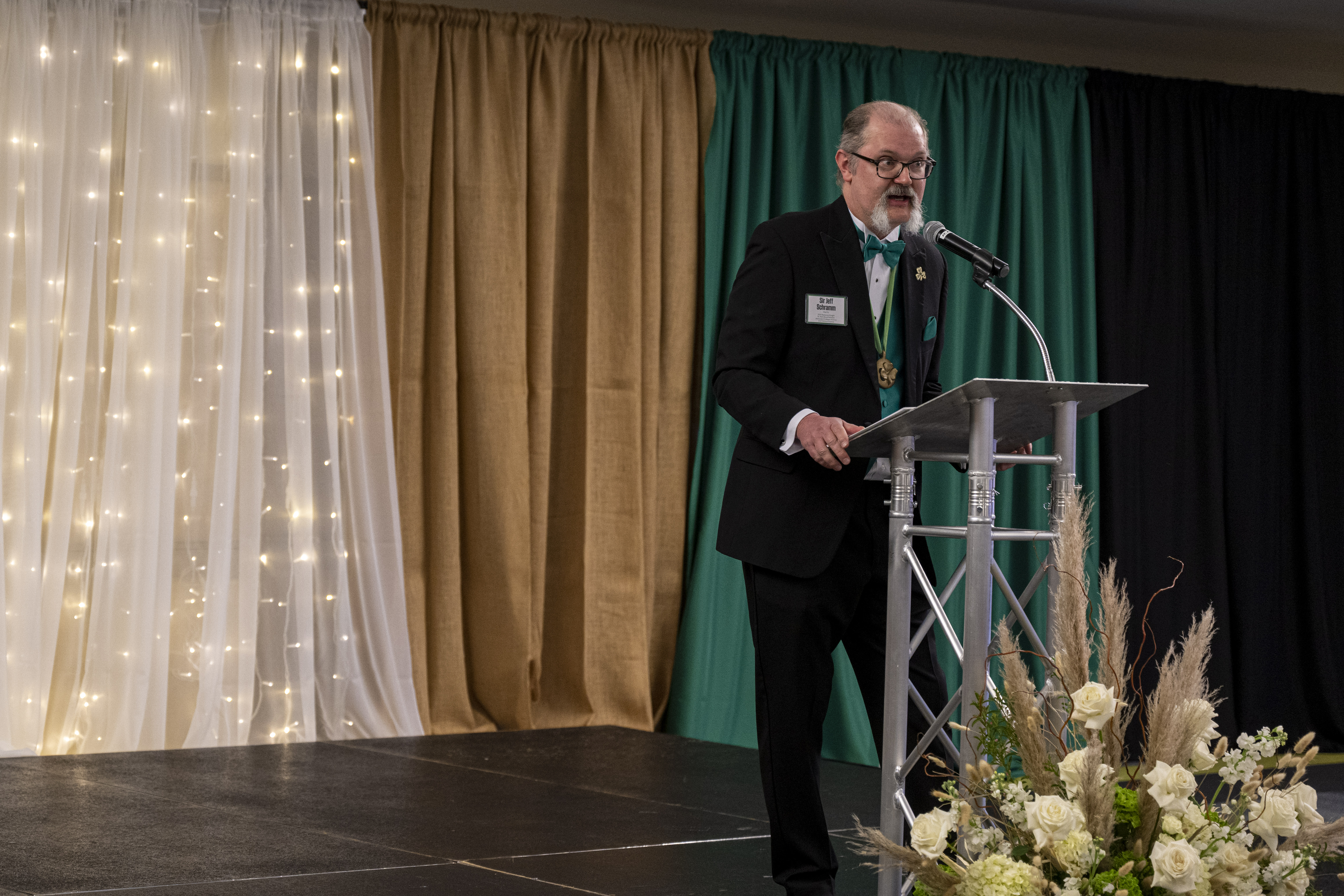 speaker at podium at nice dinner